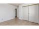 A bedroom with tile flooring, an ensuite bath, and a large closet at 1017 Falconhead Ln # 101, Las Vegas, NV 89128