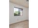A bedroom featuring a large window and tile flooring at 1017 Falconhead Ln # 101, Las Vegas, NV 89128