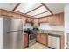 Cozy kitchen with stainless steel appliances, wood cabinets, and granite countertops at 1017 Falconhead Ln # 101, Las Vegas, NV 89128