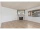 Bright living room with a stone fireplace, neutral tile flooring and ample natural light from the window at 1017 Falconhead Ln # 101, Las Vegas, NV 89128