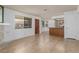 Open-concept living space with tile flooring, a stone fireplace, and seamless flow to the kitchen at 1017 Falconhead Ln # 101, Las Vegas, NV 89128