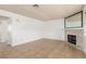 Comfortable living room with tile floors, stone fireplace, and plenty of natural light at 1017 Falconhead Ln # 101, Las Vegas, NV 89128