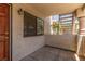 Cozy patio area with a solid door, window, concrete flooring and convenient stair access at 1017 Falconhead Ln # 101, Las Vegas, NV 89128