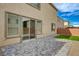 The backyard includes a covered patio, sliding glass doors, and a small artificial turf area at 10198 Eden Mountain St, Las Vegas, NV 89141