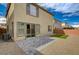 This backyard has a stone-tiled patio, artificial turf, and minimal landscaping at 10198 Eden Mountain St, Las Vegas, NV 89141