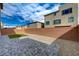 The backyard features a brick privacy wall, stone ground cover, and artificial turf at 10198 Eden Mountain St, Las Vegas, NV 89141