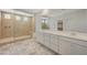 Luxurious bathroom featuring marble floors, dual sinks, and a large glass-enclosed walk-in shower at 10198 Eden Mountain St, Las Vegas, NV 89141