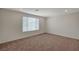 Bedroom featuring natural light from a large window and carpet flooring at 10198 Eden Mountain St, Las Vegas, NV 89141