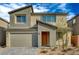 Charming two-story home with desert landscaping, a two-car garage and an inviting orange front door at 10198 Eden Mountain St, Las Vegas, NV 89141