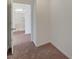 Hallway features neutral paint, carpet flooring, and white baseboards at 10198 Eden Mountain St, Las Vegas, NV 89141