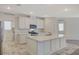 Kitchen featuring white cabinets, stainless appliances and a large center island with quartz countertops at 10198 Eden Mountain St, Las Vegas, NV 89141
