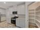 Kitchen featuring stainless appliances, quartz countertops and white cabinets, with access to a pantry at 10198 Eden Mountain St, Las Vegas, NV 89141