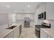 Contemporary kitchen featuring stainless steel appliances, marble tile flooring and bright white cabinetry at 10198 Eden Mountain St, Las Vegas, NV 89141