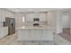 Bright kitchen featuring an island, stainless steel appliances, white cabinets, and marble-style flooring at 10198 Eden Mountain St, Las Vegas, NV 89141
