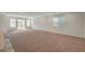 Spacious living room with neutral carpet, recessed lighting, and large windows providing ample natural light at 10198 Eden Mountain St, Las Vegas, NV 89141