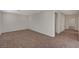 Neutral carpeted area with three door openings at 10198 Eden Mountain St, Las Vegas, NV 89141