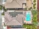 Aerial view showcasing the backyard pool, patio, and landscaping, plus the house's roof and neighboring homes at 10506 Arnica Way, Las Vegas, NV 89135