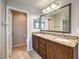 Bathroom featuring double sink vanity and a view into a separate toilet room at 10506 Arnica Way, Las Vegas, NV 89135