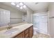 Bathroom with a single sink vanity, a shower, and chrome fixtures at 10506 Arnica Way, Las Vegas, NV 89135