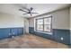 Bedroom featuring wainscotting and a ceiling fan at 10506 Arnica Way, Las Vegas, NV 89135