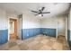 Bedroom featuring wainscotting, ceiling fan, and access to the bathroom and closet at 10506 Arnica Way, Las Vegas, NV 89135
