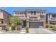 Charming two-story home featuring a stone-accented facade, well-manicured landscaping, and a two-car garage at 10506 Arnica Way, Las Vegas, NV 89135