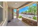 Cozy front porch with stone pillars offering a view of the street and lush landscaping at 10506 Arnica Way, Las Vegas, NV 89135