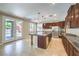 Bright kitchen featuring granite countertops, a large island, stainless steel appliances, and access to the backyard at 10506 Arnica Way, Las Vegas, NV 89135