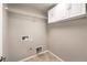 Laundry room with white cabinetry, utility hookups, and tile floor at 10506 Arnica Way, Las Vegas, NV 89135