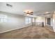 Large, open living area with neutral walls and stylish ceiling fan at 10506 Arnica Way, Las Vegas, NV 89135