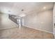 Spacious living area boasting tile floors, staircase access, and contemporary lighting at 10506 Arnica Way, Las Vegas, NV 89135