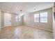 Spacious living room featuring tile floors, plenty of natural light, and a modern light fixture at 10506 Arnica Way, Las Vegas, NV 89135