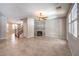 Bright living room with tile floors, a ceiling fan, and a modern fireplace feature at 10506 Arnica Way, Las Vegas, NV 89135