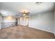 Spacious living room featuring a modern ceiling fan and neutral colored walls at 10506 Arnica Way, Las Vegas, NV 89135