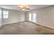 Neutral toned living space with a patio door and a ceiling fan at 10506 Arnica Way, Las Vegas, NV 89135