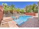 Inviting backyard oasis with a sparkling pool, spa, lush landscaping, and private patio area perfect for relaxation and entertaining at 10506 Arnica Way, Las Vegas, NV 89135
