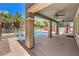 Inviting covered patio with ceiling fans overlooking a sparkling pool and spa, surrounded by lush landscaping at 10506 Arnica Way, Las Vegas, NV 89135