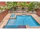 Backyard view of a sparkling pool and spa with lush landscaping and privacy wall at 10506 Arnica Way, Las Vegas, NV 89135