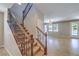 Elegant staircase with decorative iron railing leading to the upper level and living area at 10506 Arnica Way, Las Vegas, NV 89135