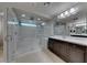 Bathroom featuring dual sinks, tile flooring, recessed lighting, plus separate tub and shower with glass surround at 10598 Aphrodite St, Las Vegas, NV 89183