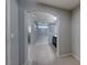 Open doorway showcasing a spacious bathroom with tile flooring, glass-enclosed shower and tub, and dark wood vanity at 10598 Aphrodite St, Las Vegas, NV 89183