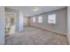 Large bedroom with carpeted floors, bright windows, and an ensuite bathroom with a tub and shower at 10598 Aphrodite St, Las Vegas, NV 89183