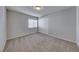 Bedroom showcasing carpeted floors, neutral paint, one window, and a double-door closet at 10598 Aphrodite St, Las Vegas, NV 89183