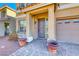 Inviting front entrance with a covered porch, tiled walkway, and beautiful landscaping at 10598 Aphrodite St, Las Vegas, NV 89183