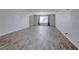 Spacious living room with wood-look tile flooring and neutral paint at 10598 Aphrodite St, Las Vegas, NV 89183