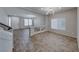 Open floor plan showcasing a spacious living room area with wood-look tile and modern lighting at 10598 Aphrodite St, Las Vegas, NV 89183