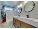 Modern bathroom featuring double sinks with modern cabinetry and a shower/tub combo at 10908 Royal Highlands St, Las Vegas, NV 89141