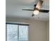 Bedroom featuring a modern ceiling fan and a window overlooking trees at 10908 Royal Highlands St, Las Vegas, NV 89141