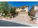 Lovely two-story home featuring a paved driveway, desert landscaping, and an attached two-car garage at 10908 Royal Highlands St, Las Vegas, NV 89141