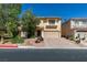 Charming two-story home with a well-maintained front yard and a paved driveway on a sunny day at 10908 Royal Highlands St, Las Vegas, NV 89141